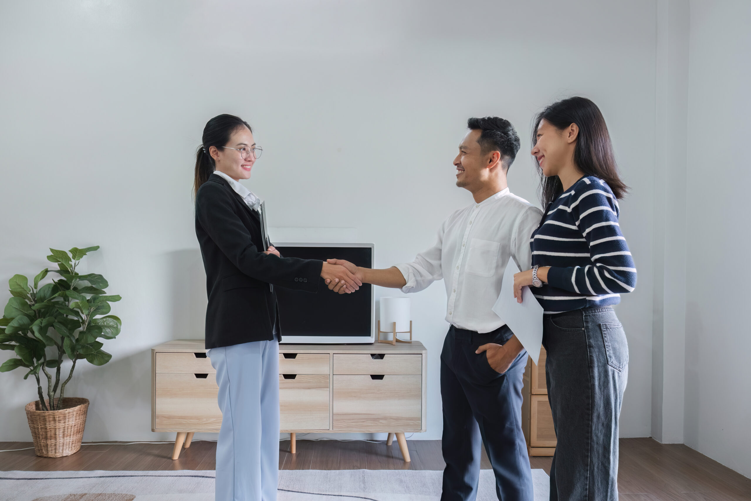 Real estate agent shaking hands with home sellers